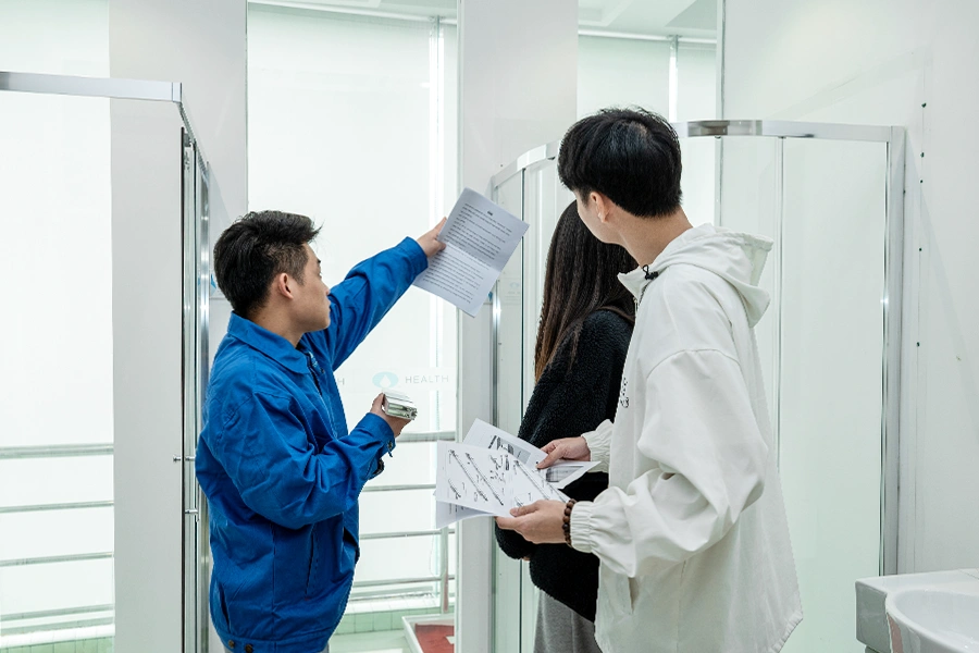 three people checking the quality of shower enclosure