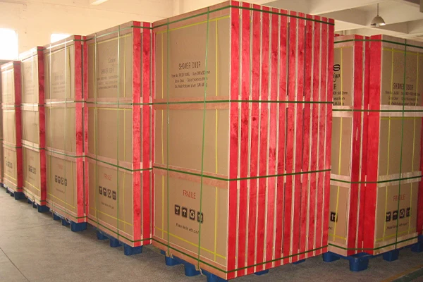 Shower door cartons strapped on pallets in a warehouse ready for container loading