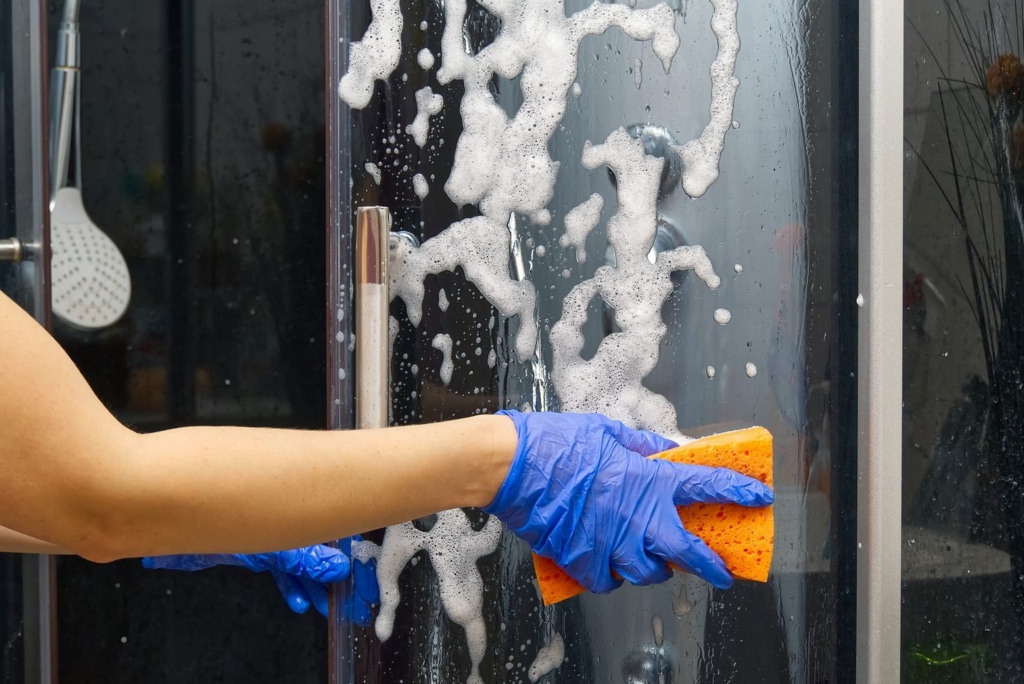 a people wiping the shower door