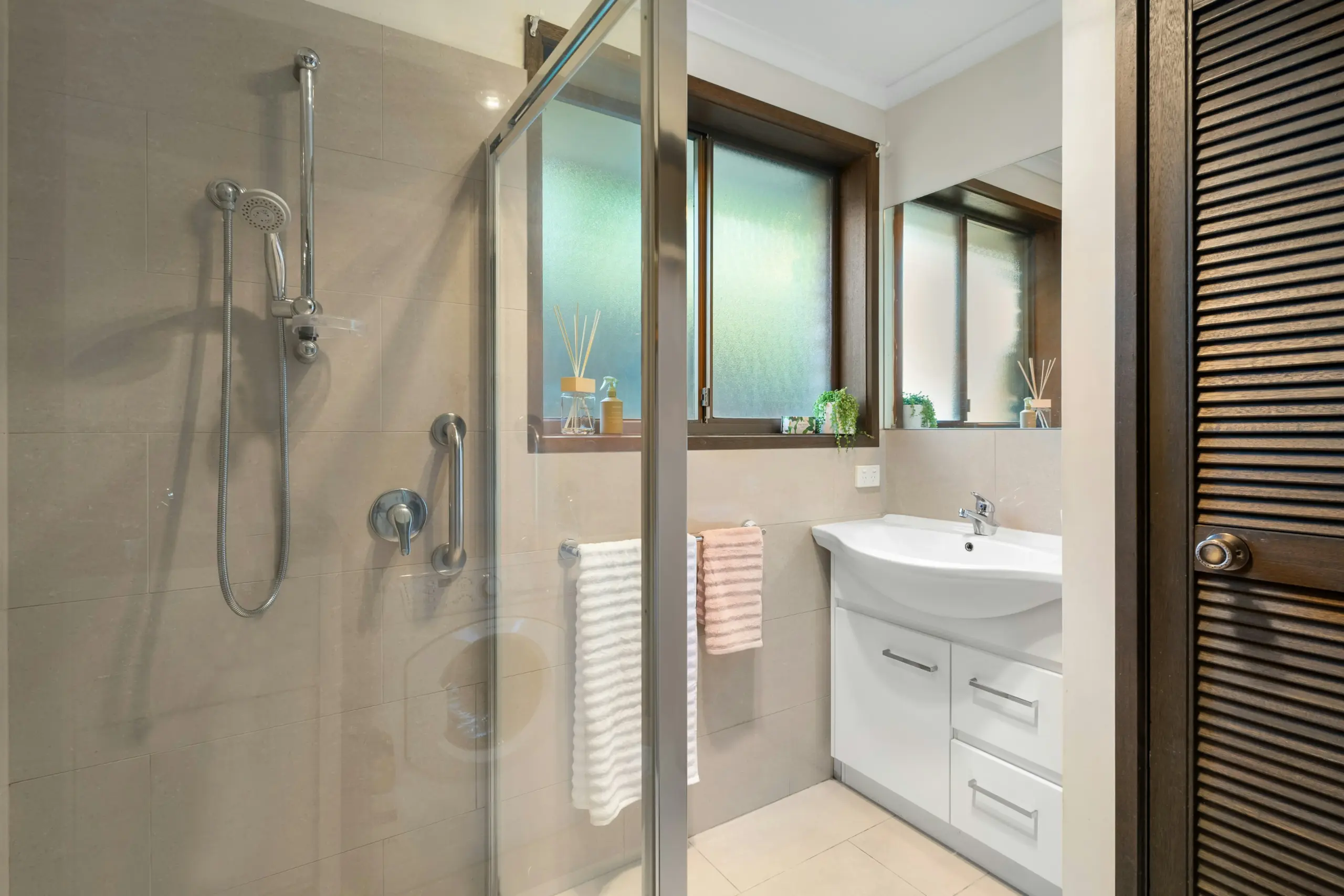 Modern bathroom interior with a glass walk-in shower enclosure